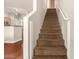 Carpeted staircase with white railings leads to the upper level of the home at 1350 S Greenfield Rd # 1040, Mesa, AZ 85206