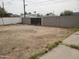 Fenced-in dirt backyard with a block wall and a gated entrance to another yard at 1363 E Clarendon Ave, Phoenix, AZ 85014