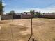 Dirt backyard with a clothesline pole, a block wall fence, and a clear sky at 1363 E Clarendon Ave, Phoenix, AZ 85014