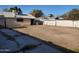 Dirt backyard with a sidewalk, a block wall fence, and some shrubbery at 1363 E Clarendon Ave, Phoenix, AZ 85014