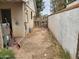 Dirt backyard with aged block wall and wooden fence against the back of the house at 1363 E Clarendon Ave, Phoenix, AZ 85014