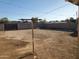 Fenced in dirt backyard with a clothesline pole and a block wall fence at 1363 E Clarendon Ave, Phoenix, AZ 85014