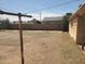 Fenced in dirt backyard with a clothesline, a block wall fence, and clear sky at 1363 E Clarendon Ave, Phoenix, AZ 85014