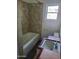 Bathroom featuring a bathtub and vintage sink with tile at 1363 E Clarendon Ave, Phoenix, AZ 85014