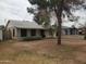 Inviting single-story home with a well-kept lawn and mature trees creating a serene setting at 1363 E Clarendon Ave, Phoenix, AZ 85014