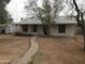 Quaint single-story home with a walkway leading to the entrance and desert-friendly landscaping at 1363 E Clarendon Ave, Phoenix, AZ 85014