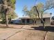 Well-maintained house with desert landscaping, mature trees, and a charming single-story design at 1363 E Clarendon Ave, Phoenix, AZ 85014