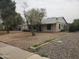Cozy home featuring desert landscaping, mature trees, and a charming single-story design at 1363 E Clarendon Ave, Phoenix, AZ 85014