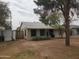 Cozy house with mature trees, a well-manicured lawn, and a charming single-story design at 1363 E Clarendon Ave, Phoenix, AZ 85014