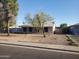 Charming single-story home with mature trees, a walkway to the front door, and desert landscaping at 1363 E Clarendon Ave, Phoenix, AZ 85014