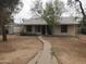 Single-story home with a walkway, a well-maintained yard, and mature trees adding character at 1363 E Clarendon Ave, Phoenix, AZ 85014