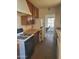 View of the kitchen featuring older cabinetry, a stove, and a refrigerator at 1363 E Clarendon Ave, Phoenix, AZ 85014