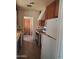 View of the kitchen featuring older cabinetry, a stove, and a refrigerator at 1363 E Clarendon Ave, Phoenix, AZ 85014