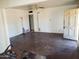 An empty living room featuring a ceiling fan, light fixture, and multiple doorways at 1363 E Clarendon Ave, Phoenix, AZ 85014