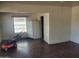 An empty living room featuring a window, refrigerator, and an open doorway at 1363 E Clarendon Ave, Phoenix, AZ 85014