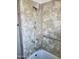 Bathtub shower combo with patterned shower walls and grab bar at 1363 E Clarendon Ave, Phoenix, AZ 85014