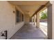 Covered back porch with a ceiling fan, columns, and concrete flooring at 14440 W Cholla St, Surprise, AZ 85379