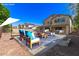 Outdoor patio area with seating, a shaded dining area, and landscaped surroundings at 14440 W Cholla St, Surprise, AZ 85379