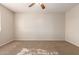 This carpeted bedroom features neutral walls and an electrical outlet at 14440 W Cholla St, Surprise, AZ 85379