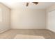 This carpeted bedroom features neutral walls, a closet, and electrical outlets at 14440 W Cholla St, Surprise, AZ 85379