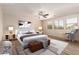 Spacious bedroom featuring a ceiling fan, plush carpet, and large windows for ample natural light at 14440 W Cholla St, Surprise, AZ 85379