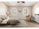 Serene bedroom with neutral tones, a comfortable bed, and a stylish accent chair at 14440 W Cholla St, Surprise, AZ 85379