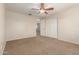 Spacious bedroom featuring neutral walls, carpeted floor, ceiling fan, and closet at 14440 W Cholla St, Surprise, AZ 85379