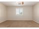 Bedroom features neutral walls, carpeted floors, and a window with plantation shutters at 14440 W Cholla St, Surprise, AZ 85379