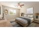 Calm bedroom featuring a wood frame bed, neutral decor, and natural light from the window at 14440 W Cholla St, Surprise, AZ 85379