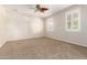 Expansive bedroom with plush carpet, and natural light from the shuttered windows at 14440 W Cholla St, Surprise, AZ 85379