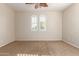 Bright bedroom features dual shuttered windows and carpeted floors at 14440 W Cholla St, Surprise, AZ 85379