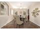 Dining room featuring a decorative light fixture, large artwork, and a dining table with six chairs at 14440 W Cholla St, Surprise, AZ 85379