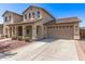 Charming two-story home featuring a spacious driveway, a two-car garage, and well-maintained landscaping at 14440 W Cholla St, Surprise, AZ 85379