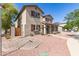 Lovely two-story home with well-manicured landscaping, including decorative rock and lush green bushes at 14440 W Cholla St, Surprise, AZ 85379
