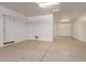 This bright white garage features concrete flooring and a service door to the house at 14440 W Cholla St, Surprise, AZ 85379
