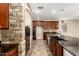 Well-lit kitchen featuring an island, stainless steel appliances, and a stone accent wall at 14440 W Cholla St, Surprise, AZ 85379