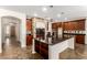 Spacious kitchen with a large island, dark countertops, and dark wood cabinets at 14440 W Cholla St, Surprise, AZ 85379