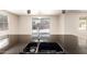 The kitchen features a double sink with a view to the backyard patio at 14440 W Cholla St, Surprise, AZ 85379