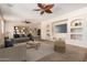 Cozy living room with neutral walls, comfortable seating, and a built-in media center at 14440 W Cholla St, Surprise, AZ 85379