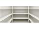 A well-organized, spacious, walk-in closet features built-in shelving at 14440 W Cholla St, Surprise, AZ 85379