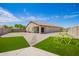 Backyard features artificial turf, stone pavers, play structure, and string lights at 14809 N El Frio Cir, El Mirage, AZ 85335
