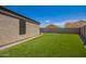 Spacious backyard featuring artificial turf, providing a low-maintenance and vibrant outdoor space at 14809 N El Frio Cir, El Mirage, AZ 85335