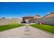 Backyard with artificial turf, pergola with seating area, and stone pathway at 14809 N El Frio Cir, El Mirage, AZ 85335