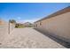 Spacious backyard boasts an extended patio, a privacy wall, and lush landscaping at 14809 N El Frio Cir, El Mirage, AZ 85335