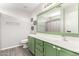 Bathroom featuring a large mirror and green vanity with white countertops at 14809 N El Frio Cir, El Mirage, AZ 85335