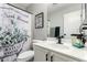 Bathroom features a tub with patterned shower curtain, framed art, and vanity with sink at 14809 N El Frio Cir, El Mirage, AZ 85335
