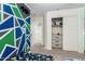 Spacious bedroom featuring a closet, accent wall, and playful decor at 14809 N El Frio Cir, El Mirage, AZ 85335