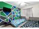 Bright bedroom featuring two beds, colorful accent wall, and a ceiling fan at 14809 N El Frio Cir, El Mirage, AZ 85335