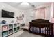 Cozy Bedroom with a dark wood crib, plush decor, and a decorative chandelier at 14809 N El Frio Cir, El Mirage, AZ 85335