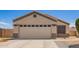 Single story home with a two car garage, desert landscaping, and a driveway with paved walkway at 14809 N El Frio Cir, El Mirage, AZ 85335